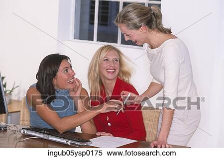 Three young women talking in an office View Large Photo Image Stock Photography - Three young women talking in an office. Fotosearch