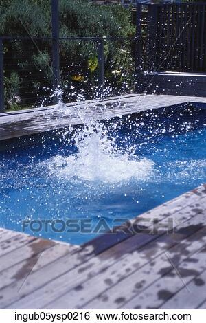 Stock Photograph - View of a splash in a swimming pool. Fotosearch
