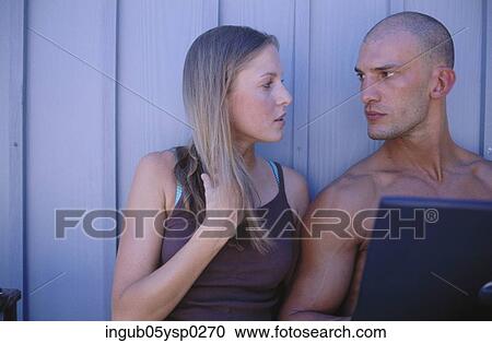 Stock Image - Young couple looking at each other. Fotosearch