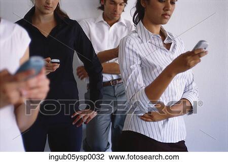 Young man and a group of young women using mobile phones View Large Photo Image Stock Image - Young man and a group of young women using mobile phones. Fotosearch