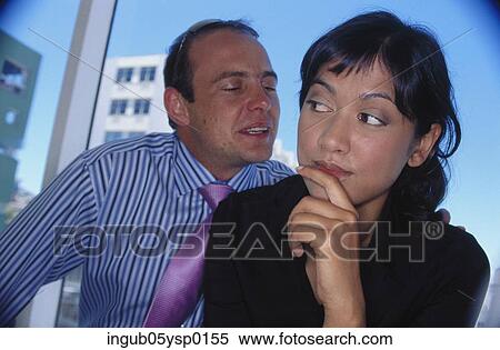 Young man whispering into a young woman's ear View Large Photo Image Stock Photography - Young man whispering into a young woman's ear. Fotosearch