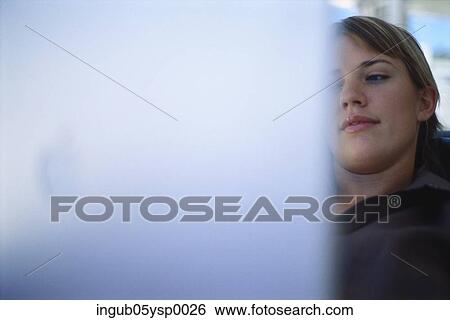 Young woman sitting in front of a computer monitor View Large Photo Image Stock Photograph - Young woman sitting in front of a computer monitor. Fotosearch