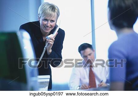 Young woman talking on a telephone View Large Photo Image Stock Photo - Young woman talking on a telephone. Fotosearch