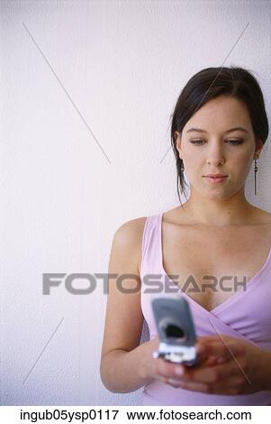 Stock Photo - Young woman using a mobile phone. Fotosearch