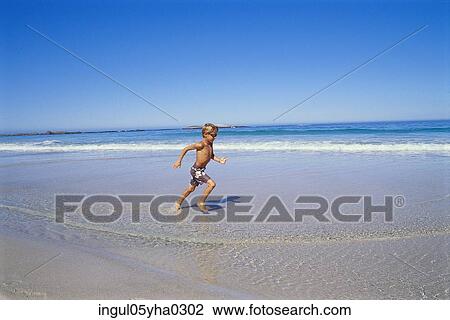 Boy running on the beach View Large Photo Image Stock Image - Boy running on the beach. Fotosearch