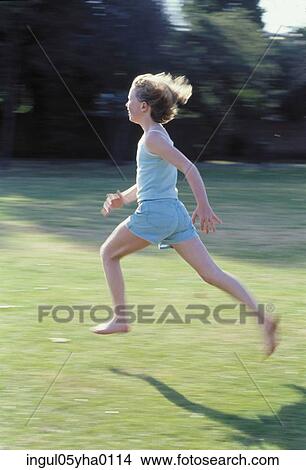 Picture - Girl running on a lawn. Fotosearch