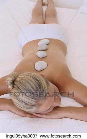 High angle view of a young woman with therapeutic stones on her back View Large Photo Image Stock Photo - High angle view of a young woman with therapeutic stones on her back. Fotosearch