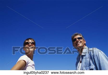 Low angle view of a mid adult couple View Large Photo Image Stock Photo - Low angle view of a mid adult couple. Fotosearch