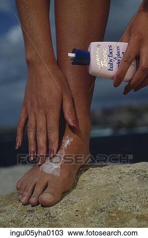 Low section view of a woman applying cream on her foot View Large Photo Image Stock Image - Low section view of a woman applying cream on her foot. Fotosearch