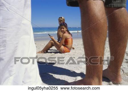 Low section view of two people standing on the beach View Large Photo Image Stock Photography - Low section view of two people standing on the beach. Fotosearch