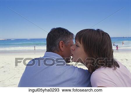 Mid adult couple sitting together on the beach View Large Photo Image Stock Image - Mid adult couple sitting together on the beach. Fotosearch