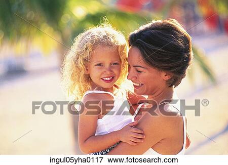Mother carrying her daughter View Large Photo Image Stock Photo - Mother carrying her daughter. Fotosearch