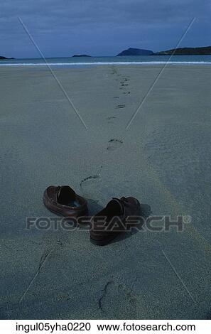 Stock Image - Pair of shoes on the beach. Fotosearch