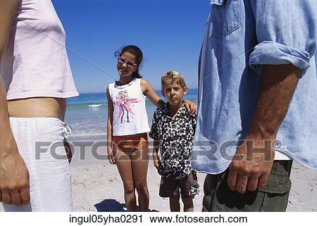 Parents standing on the beach with their son and daughter View Large Photo Image Stock Image - Parents standing on the beach with their son and daughter. Fotosearch