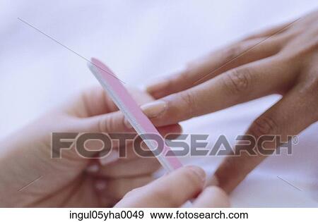 Stock Photo - Person getting a manicure. Fotosearch