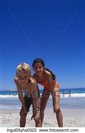 Portrait of a boy and a girl standing on the beach View Large Photo Image Stock Image - Portrait of a boy and a girl standing on the beach. Fotosearch