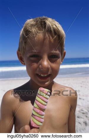 Stock Image - Portrait of a boy holding an ice cream. Fotosearch