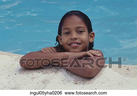 Stock Photograph - Portrait of a girl in a swimming pool. Fotosearch