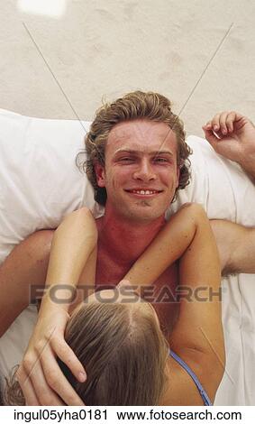 Portrait of a young man and a young woman lying in bed View Large Photo Image Stock Image - Portrait of a young man and a young woman lying in bed. Fotosearch