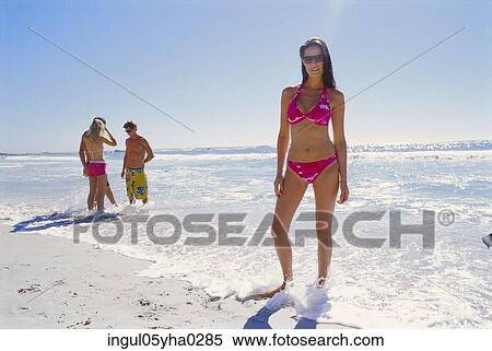 Portrait of a young woman standing on the beach View Large Photo Image Stock Photography - Portrait of a young woman standing on the beach. Fotosearch