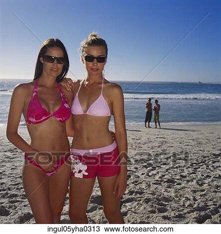 Portrait of two young women standing on the beach View Large Photo Image Stock Image - Portrait of two young women standing on the beach. Fotosearch