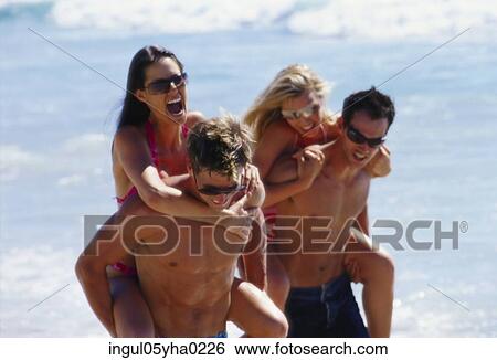 Two young couples on the beach View Large Photo Image Stock Photograph - Two young couples on the beach. Fotosearch