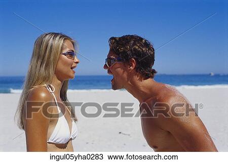 Young couple looking at each other on the beach View Large Photo Image Stock Image - Young couple looking at each other on the beach. Fotosearch