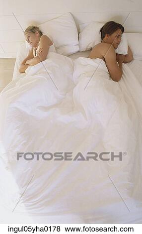 Young couple lying in bed View Large Photo Image Stock Photo - Young couple lying in bed. Fotosearch