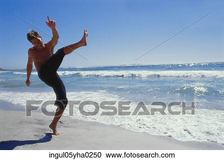 Young man on the beach View Large Photo Image Stock Image - Young man on the beach. Fotosearch