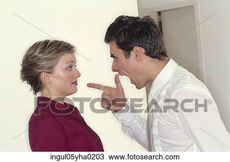 Stock Image - Young man shouting at a young woman. Fotosearch