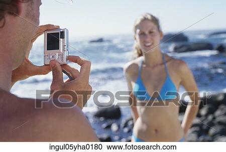 Young man taking a photograph of a young woman View Large Photo Image Stock Image - Young man taking a photograph of a young woman. Fotosearch