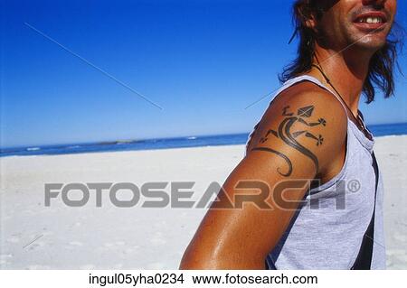 Young man with a tattoo on his arm View Large Photo Image Picture - Young man with a tattoo on his arm. Fotosearch
