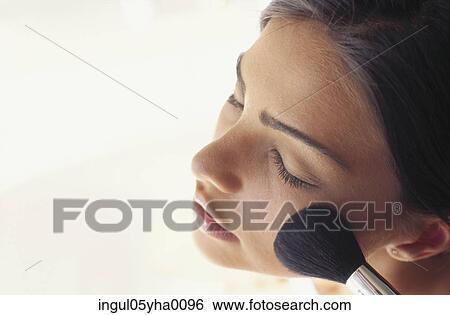Young woman applying blush View Large Photo Image Stock Photograph - Young woman applying blush. Fotosearch
