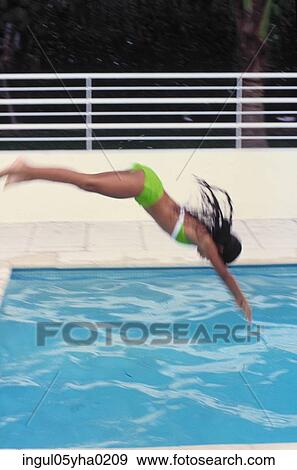 Young woman diving into a swimming pool View Large Photo Image Stock Photo - Young woman diving into a swimming pool. Fotosearch