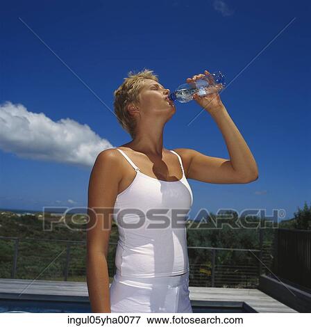 Stock Photo - Young woman drinking water. Fotosearch