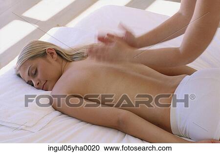 Stock Image - Young woman getting a back massage. Fotosearch