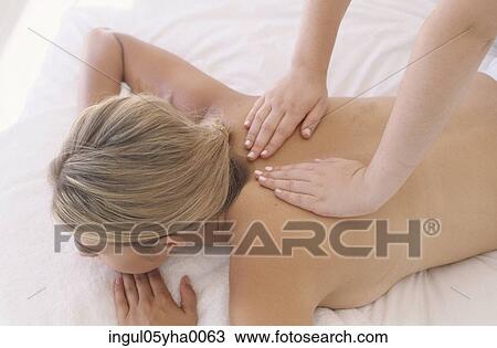 Stock Image - Young woman getting a back massage. Fotosearch