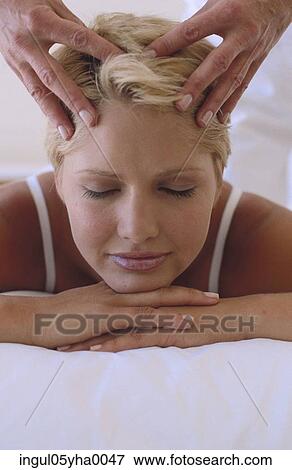 Young woman getting a head massage View Large Photo Image Stock Photo - Young woman getting a head massage. Fotosearch