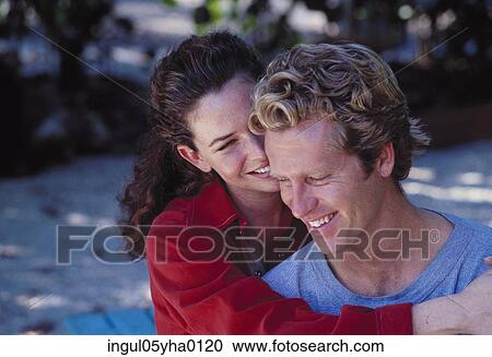 Young woman holding a young man View Large Photo Image Stock Image - Young woman holding a young man. Fotosearch