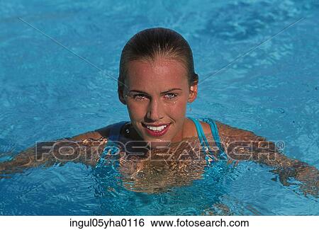 Young woman in a swimming pool View Large Photo Image Stock Photograph - Young woman in a swimming pool. Fotosearch