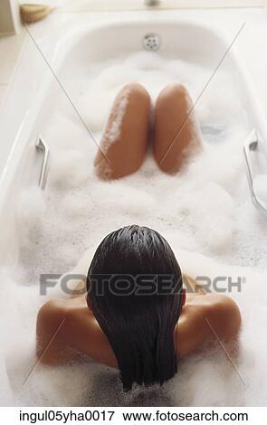 Young woman taking a bubble bath View Large Photo Image Stock Photo - Young woman taking a bubble bath. Fotosearch