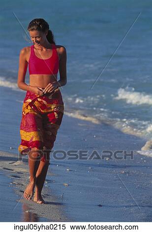 Young woman walking on the beach View Large Photo Image Stock Photography - Young woman walking on the beach. Fotosearch