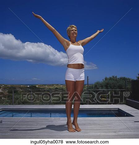 Stock Photo - Young woman with her arms stretched out. Fotosearch