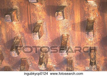 Picture - Close-up of a metal panel with square spokes. Fotosearch