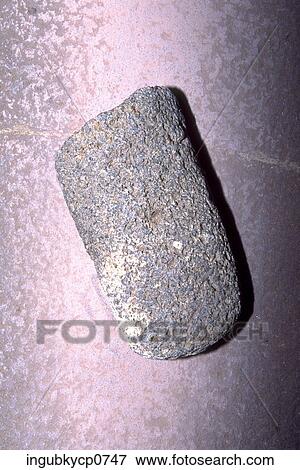 Stock Photo - Close-up of a rock kept on a rock formation. Fotosearch