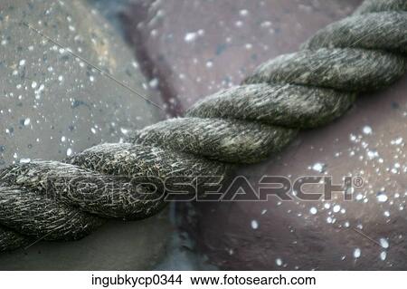 Close-up of a rope against a stone surface View Large Photo Image Picture - Close-up of a rope against a stone surface. Fotosearch