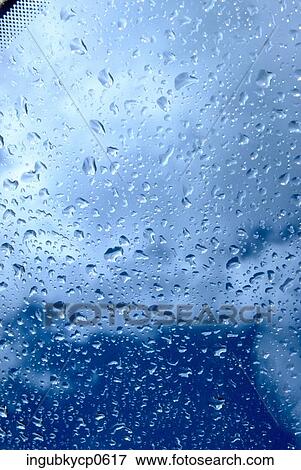 Close-up of raindrops through a glass pane View Large Photo Image Stock Photo - Close-up of raindrops through a glass pane. Fotosearch