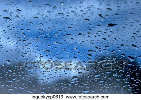 Close-up of raindrops through a glass pane View Large Photo Image Stock Photo - Close-up of raindrops through a glass pane. Fotosearch
