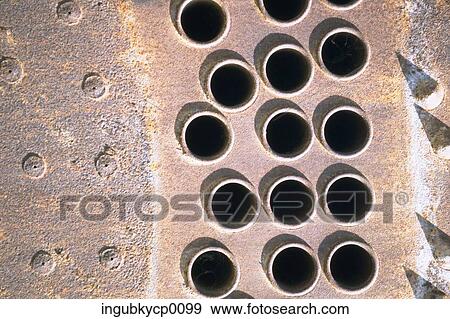 Stock Photo - Close-up of rivets and holes on a metal surface. Fotosearch