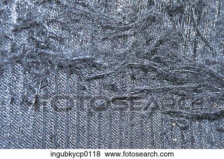 Stock Photo - Close-up of tassels on a shiny fabric. Fotosearch